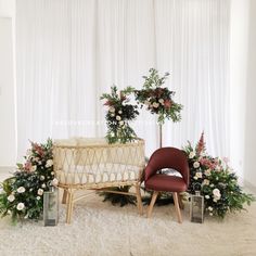 a baby crib with flowers and greenery next to it