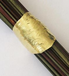 chopsticks with gold foil on them sitting next to each other