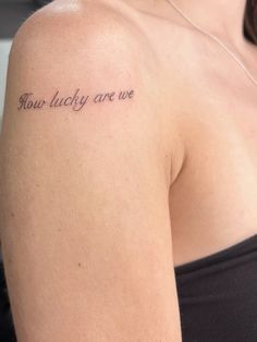 a woman with a tattoo on her shoulder that says, how lucky are we?