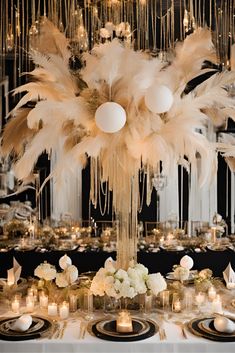 the centerpieces are adorned with white flowers, feathers and chandelier hanging from the ceiling