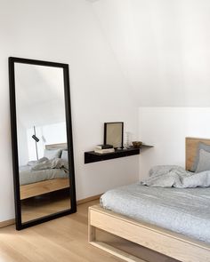 a bedroom with a large mirror on the wall