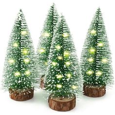 three small christmas trees with lights on them