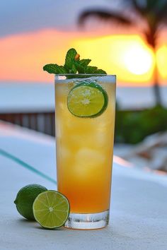 a tall glass filled with lemonade and lime