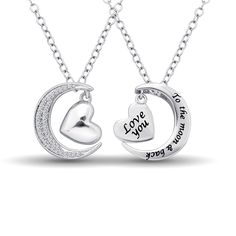 This adorable Duel sided Moon and Heart Pendant crafted in sterling silver, One sided heart shaped design features an engraved with saying ?Love You ? To the moon & back? and another side of moon sparkle with twinkling diamonds of 1/8 ctw, plain heart dangle inside that. This pendant suspends along an 18.0-inch chain that secures with a spring-ring clasp. Shape: Round Minimum Total Carat Weight: 0.12 ct. Color / Clarity: GH / I2 Setting: Prong Number of Stones: 35 Heart Moon, Stackable Wedding Bands, Trending Engagement Rings, Engagement Rings Bridal Sets, Valentine Special, Band Jewelry, Dragon Pendant, Jewelry Repair, Moon Pendant