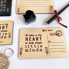 three wooden stamps with words on them and a rubber stamp that says it takes a big heart to help shape little minds