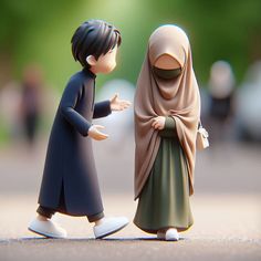 two small figurines are standing next to each other on the ground, one is wearing a headscarf