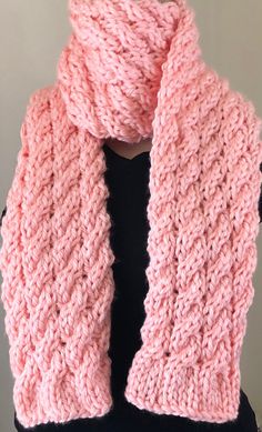 a pink knitted scarf on top of a mannequin