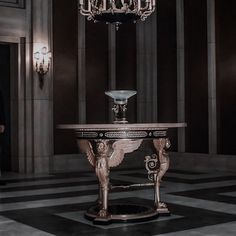 a fancy table in the middle of a room with chandelier hanging from it