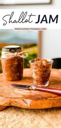 two jars filled with jam sitting on top of a wooden cutting board