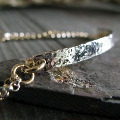 "This beautiful, handcrafted bracelet is made from sterling silver and 14k gold filled.  It is uniquely textured, hammered, and shaped to create a one-of-a-kind piece that is sure to catch attention. The Details ∞ Artisan handmade ∞ Mixed metals ~ 14k gold filled & sterling silver ∞ Hammered Bar measures 4mm wide ∞ Measures 7 1/4\" long ∞ Made to order ∞ Gift box included ∞ Made in the USA Shop for more of our bracelets... http://www.etsy.com/shop/PoseidonsBooty?section_id=6105734 VISIT OUR SHOP Mixed Metal Bracelet, Sleek Jewelry, Oxidized Silver Bracelet, Mixed Metal Bracelets, Silver Link Bracelet, Gold And Silver Bracelets, Gold Link Bracelet, Gold Link Chain, Metal Bracelet