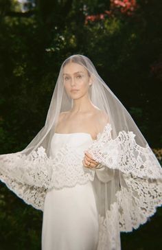 a woman in a white dress and veil