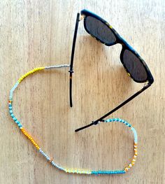 "Wood, vintage glass beaded croakie, custom made in Denver, CO. 24\" is the total length.  Stretchy cord provides a comfortable wear. Boho Chic Sunglasses Chain over 40 styles! - Adjustable Rubber Holders to keep cord in place and glasses secure! - Easy attachment, fits ALL glasses! - Perfect for Sunglasses or Reading Glasses - Stylish, comfortable and cool! Perfect for everyday activities or just looking fly in your daily routine or out and about on the scene!" Adjustable Yellow Single Strand Beaded Necklaces, Adjustable Yellow Single Strand Beaded Necklace, Adjustable Single Strand Yellow Beaded Necklaces, Adjustable Single Strand Yellow Beaded Necklace, Handmade Adjustable Glasses Chains With Round Beads, Adjustable Glass Necklaces With Tiny Beads, Adjustable Glass Beaded Necklaces With Tiny Beads, Adjustable Glass Beaded Necklace With Tiny Beads, Adjustable Glass Necklace With Tiny Beads