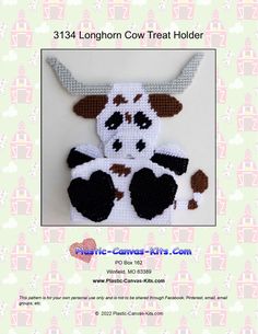 a crocheted cow is sitting on top of a white surface with the words, longhorn cow treat holder