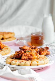 some chicken and waffles are sitting on the table