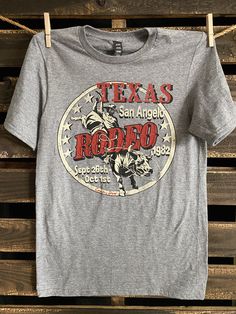 San Angelo 1980's Texas Rodeo vintage Country Western T shirt 1980's throwback Texas Rodeo Unisex T shirt Fits Unisex Country Deep unisex T shirt 4.3 oz. 60% Cotton/40% Poly Retro Tri-blend Crew Neck T-shirt, Retro Tri-blend T-shirt, Retro Tri-blend Pre-shrunk T-shirt, Retro Pre-shrunk Crew Neck Shirt, Retro Crew Neck Pre-shrunk Shirt, Retro Tri-blend T-shirt With Front Print, Retro Short Sleeve Fan Merchandise Shirt, Vintage Shirt With Front Print For Fans, American Retro Short Sleeve Graphic T-shirt