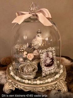 a glass clochet with pictures and pearls in it