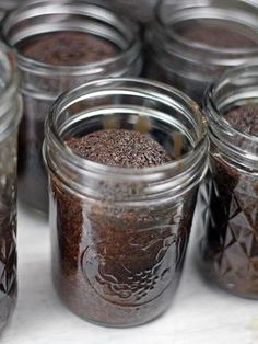 several jars filled with brown stuff sitting on top of a table