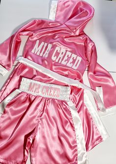 a pink and white uniform sitting on top of a table