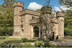 an old castle like building surrounded by trees