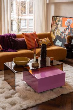 a living room filled with furniture and a large window