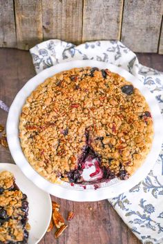 a blueberry crumble pie on a wooden table