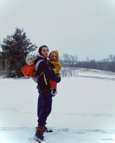 a woman and two children standing in the snow