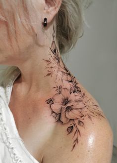 a woman's neck with flowers on it