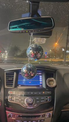 a car dashboard with disco balls hanging from the dash