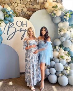 two women standing next to each other in front of a backdrop that says oh boy