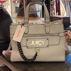 Bag Is Light Gray With Gold Tone Hardware. Inside Is The Black & White Juicy Lining. Has Open Pockets & A Zipper Pocket. Bag Is 9x12x6. Has Detachable & Adjustable Strap. The Juicy Name Is On The Front Zipper Pocket. Gray Zipper Bag For Shopping, Luxury Gray Bag With Zipper Closure, Trendy Gray Satchel For Shopping, Chic Gray Bag With Top Carry Handle, Gray Rectangular Shoulder Bag With Branded Hardware, Trendy Beige Bag With Branded Hardware, Gray Bag With Branded Hardware For Daily Use, Chic Gray Shoulder Bag With Branded Hardware, Hot Pink Bag