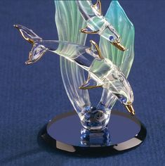 a glass figurine with two birds on it