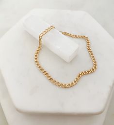 "Our flat faceted curb chain bracelet is the one for you if you are looking for a simple piece that you can live in. It's perfect in its simplicity and balance of minimal and statement and layers nicely with other bracelets. A timeless piece that will remain in your collection for years. D E T A I L S: 14k gold filled flat curb chain Tested for its top quality + tarnish & water resistance Chain width: 3.5 mm Modeled in size 6.5 Lobster clasp closure ✦ How to determine your size: 1. Measure t Gold-tone Curb Chain Bracelets As Gifts, Gold-tone Curb Chain Bracelet Gift, Formal Gold-tone Curb Chain Bracelet, Classic Gold-plated Curb Chain Bracelet, Gold-plated Curb Chain Bracelet, Gold Curb Chain, Curb Chain Bracelet, Womens Bracelet, Curb Chain