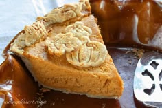 a piece of pie sitting on top of a plate covered in caramel