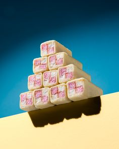 a stack of pink and white marshmallows sitting on top of each other