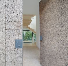 an open door leading into a room with stone walls and stairs in front of it