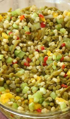 a bowl filled with corn and vegetables on top of a table