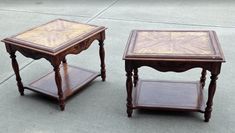 two wooden tables sitting side by side on the cement ground, one has a glass top