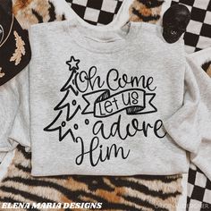 a gray sweatshirt with black lettering that says, you come and let us adore him