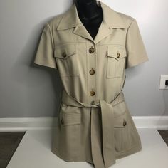 Michael Kors Tan Short Sleeve Trench Button Tie Jacket Beautiful Condition. New With Tags. Crafted In 98% Wool / 2% Elastic Size 12 ~ 18.5" Bust X 18" Waist X 29" Length Khaki Collared Blazer For Work, Short Sleeve Outerwear With Buttons For Work, Short Sleeve Outerwear With Buttons For Office, Short Sleeve Office Outerwear With Buttons, Khaki Short Sleeve Outerwear For Work, Size 12, Jackets & Coats, Michael Kors, Jackets For Women