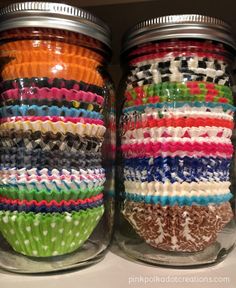 two glass jars filled with colorful cupcake liners