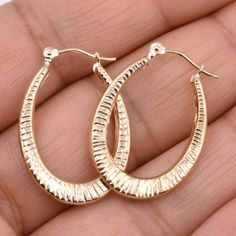 "1\" Textured Oval Hoop Earrings Real 14K Yellow Gold * Metal : Real 14K Yellow Gold (Properly Stamped, 14K) * Condition : Brand New * Finish : Polished * Avg Weight : 1.22 grams * Length : 26mm = 1\" * Width : 18.7mm = 3/4\" * Clasp/Bail : Hinged All of our items are brand new and are shipped with a gift box." Gold Oval Tarnish Resistant Hoop Earrings, Oval Tarnish Resistant Hoop Earrings As Gift, Gold Oval Hoop Earrings Tarnish Resistant, Gold Tarnish Resistant Oval Hoop Earrings, Oval Tarnish Resistant Hoop Earrings For Gift, Gold Diamond Cut Oval Hoop Earrings, Gold Oval Diamond Cut Hoop Earrings, Oval Gold Hoop Earrings With Diamond Cut, Oval Gold-plated Polished Hoop Earrings