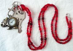 This red beaded lanyard can be used as a badge holder, an I.D. holder, keychain necklace, watch holder - it's a multi-use accessory for home or office! 34" in length, made with glass beads, beading cord, metal lobster clasp, clip, and keyring. Snap on badge holder included with every lanyard purchase. This red beaded lanyard ships to you in a gift box, ready to give as a present or to keep and store. Note: Watch not included with purchase. Back to Beaded Lanyards Red Lanyard With Key Leash As Gift, Red Lanyards With Key Leash For Gifts, Keychain Necklace, Beaded Lanyard, Beading Cord, Watch Holder, Work Badge, Beaded Lanyards, Id Badge Holders