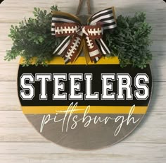 a football sign hanging on the side of a wooden wall that says steeles pittsburgh