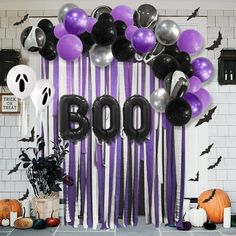 halloween decorations with balloons and bats on the wall