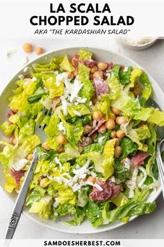 a salad with lettuce, chickpeas and parmesan cheese on top