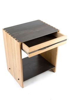 a small wooden table with two drawers on each side and an open drawer at the top