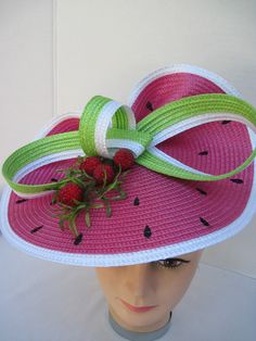 "* This design features the watermelon braiding as the hat foundation folded into design loops complemented by red raspberries and summer greens. * The hat form is about 12\" folded in back and tilted in a sophisticated design. * It is light weight, balanced and comfortable to wear year round. * Designed on a satin covered metal headband, it fits just about any head size and when viewed from any direction it looks complete, striking and eye catching. * Wear it throughout the year for special eve Red Summer Hats For Garden Party, Red Mini Hats For Spring Beach Outings, Red Mini Hats For Beach In Spring, Red Brimmed Mini Hat For Beach, Red Brimmed Mini Hat For The Beach, Whimsical Adjustable Straw Hat For Summer, Red Summer Boater Hat With Short Brim, Red Hats For Spring Garden Party, Fitted Red Straw Hat For Summer