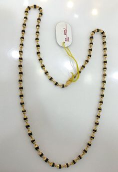 22K Gold & Tulsee seeds beads strand Necklace. Length-22", size of beads-3 mm. Hand-strung Black Jewelry For Festivals, Gold Beads With Beaded Chain For Festivals, Gold Necklaces With Black Beads For Festivals, Traditional Gold Beads With Black Details, Black Beaded Chain Necklace, Gold Long Necklace With Black Beads, Black Hand-strung Jewelry For Festivals, Yellow Gold Necklace With Black Round Beads, Mala Beads