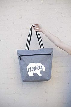 PERFECT GIFT FOR GRANDMA, NANA BEAR: Show your favorite nana bear some love with this cute, fun, unique custom tote bag. Has the fun saying Nana Bear screen printed on the front pocket of the bag. LARGE ZIPPERED TOTE BAG WITH FRONT DEEP ZIPPER POCKET: Dimensions of this bag are 14.5'' X 15'' X 5'' - Has enough room for all of your belongings and more! Includes a zippered main compartment and a zippered front sleeve deep pocket (fits up to an 11” tablet). STURDY CANVAS MATERIAL, FULLY LINED INSID Casual Travel Bag With Bear Design, Personalized Everyday Use Bags For Mother's Day, Cute Bear Design Bags For Gifts, Cute Bear Design Bags For Gift, Cute Bear Design Bags As Gifts, Cute Personalized Bags For Everyday Use, Cute Everyday Personalized Bags, Cute Personalized Everyday Bags, Zippered Tote Bag