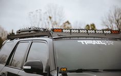 the front end of a vehicle with lights on and an off - road light attached to it